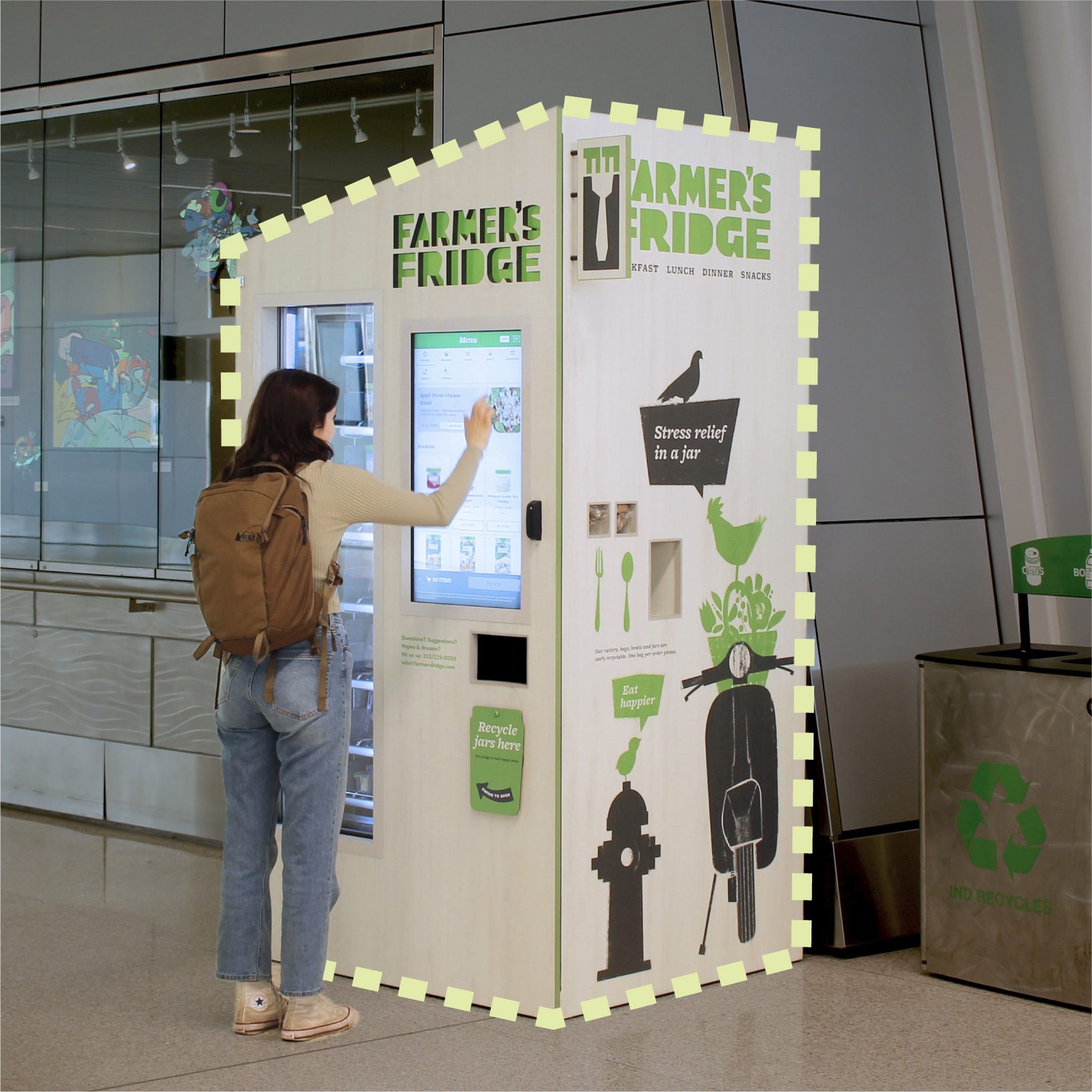 Woman using Farmer's Fridge at an airport.