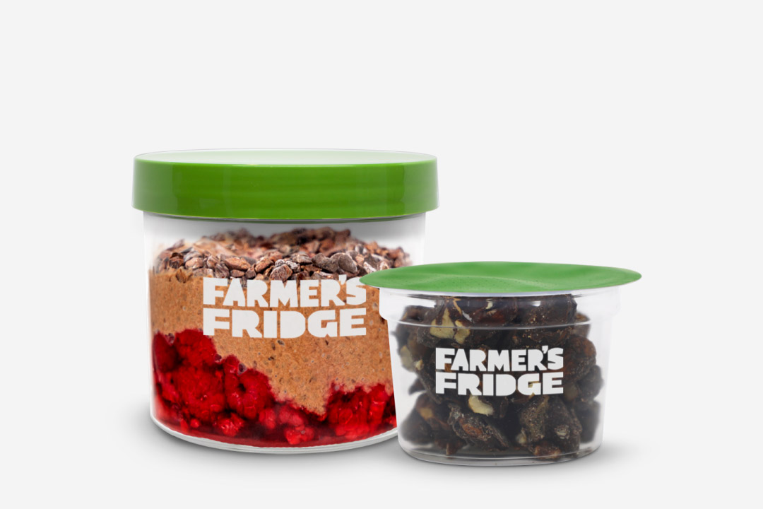 Chocolate Chia Pudding in a jar next to the Dark Chocolate Trail Mix in a small container.