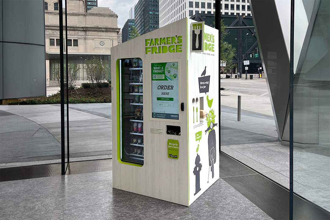 Image of a Farmer's Fridge smart vending machine in a business office lobby.