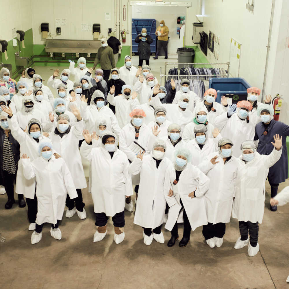A group of Farmer's Fridge workers from our Cicero facility waving to the camera. 