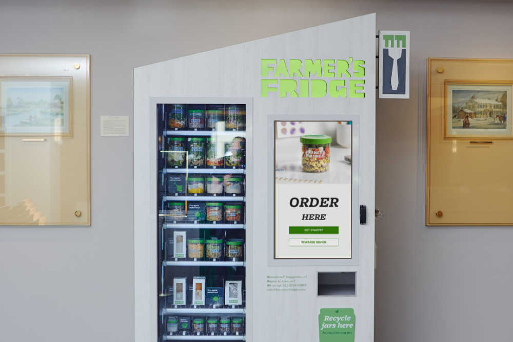 Image of a Farmer's Fridge smart vending machine in a commercial office building.