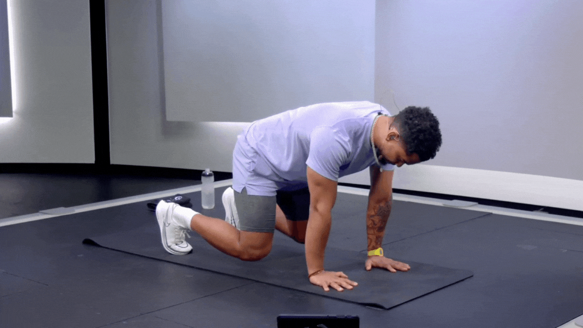 Peloton instructor Rad Lopez demonstrating a bear plank bodyweight exercise