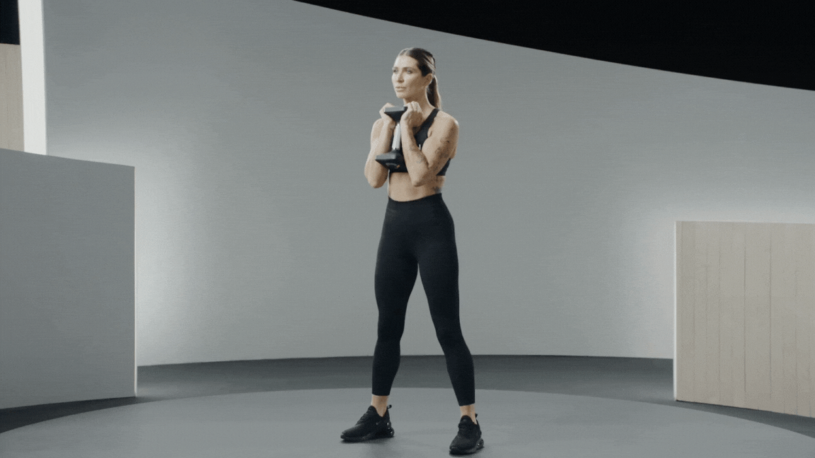 Peloton instructor Selena Samuela demonstrates a dumbbell goblet squat leg exercise.