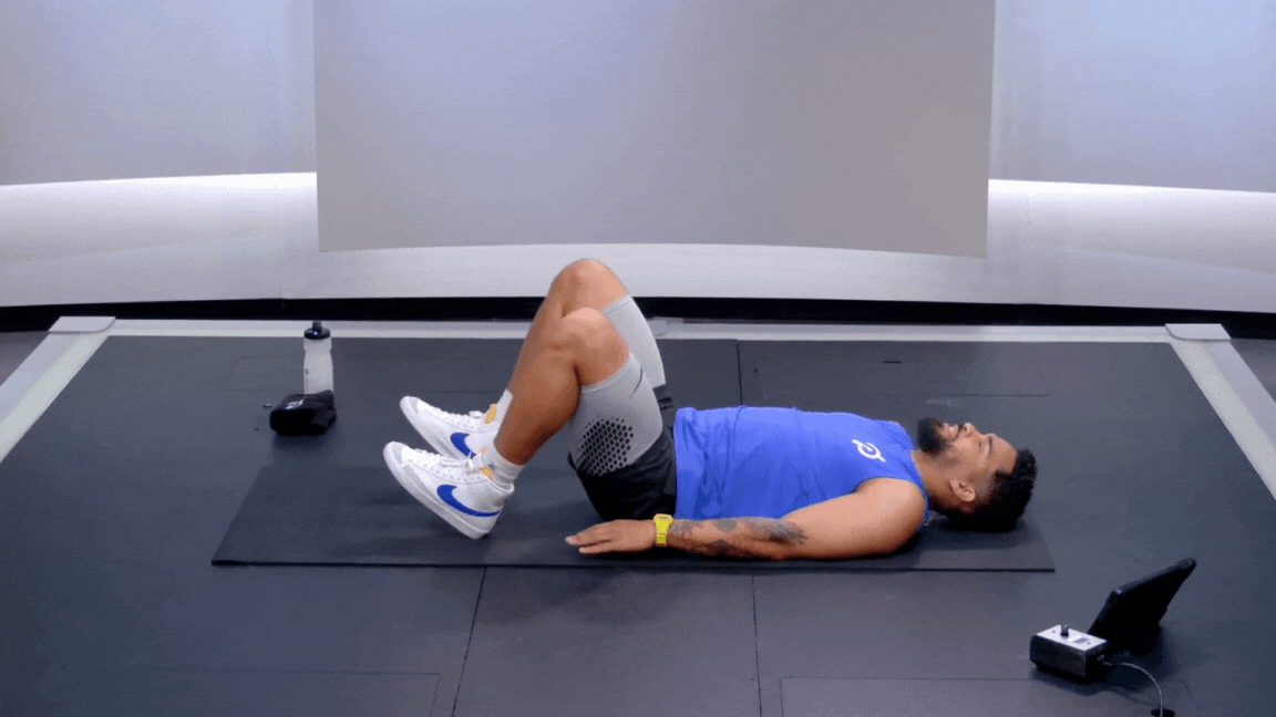 Peloton instructor Rad Lopez demonstrates a hip bridge (aka glute bridge) as a bodyweight exercise