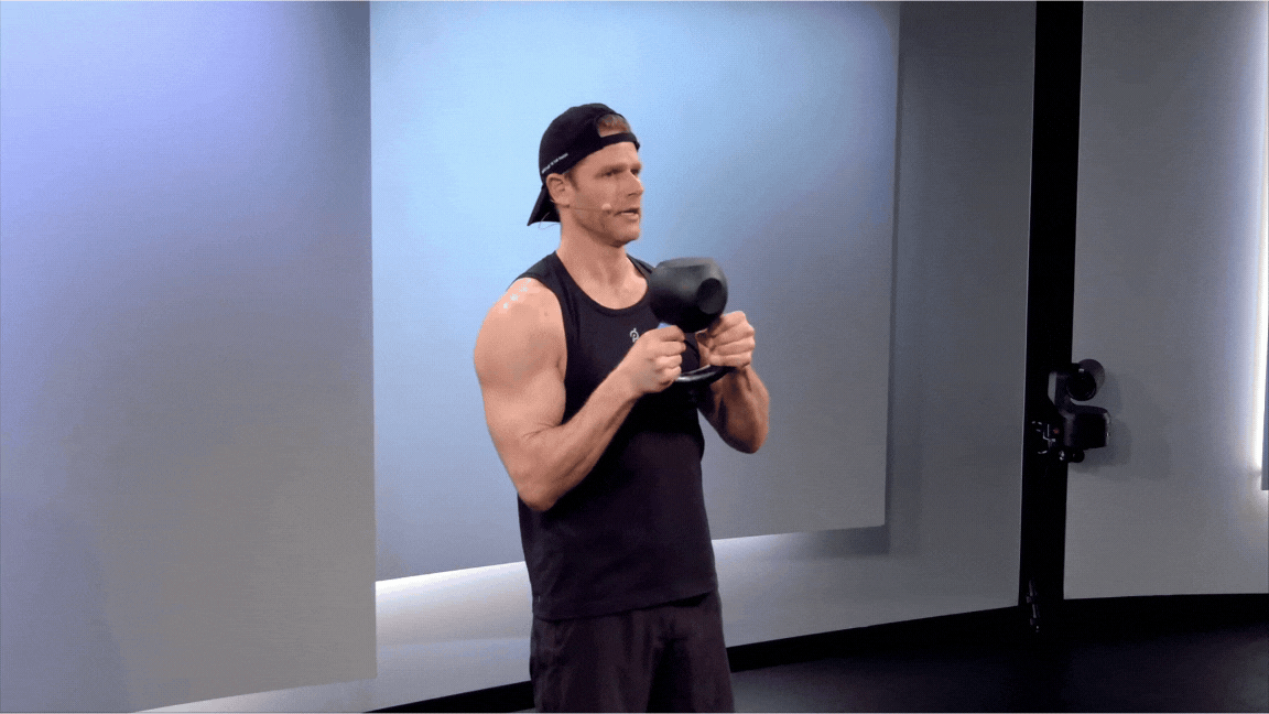 Peloton instructor Andy Speer demonstrates a kettlebell halo with proper form.