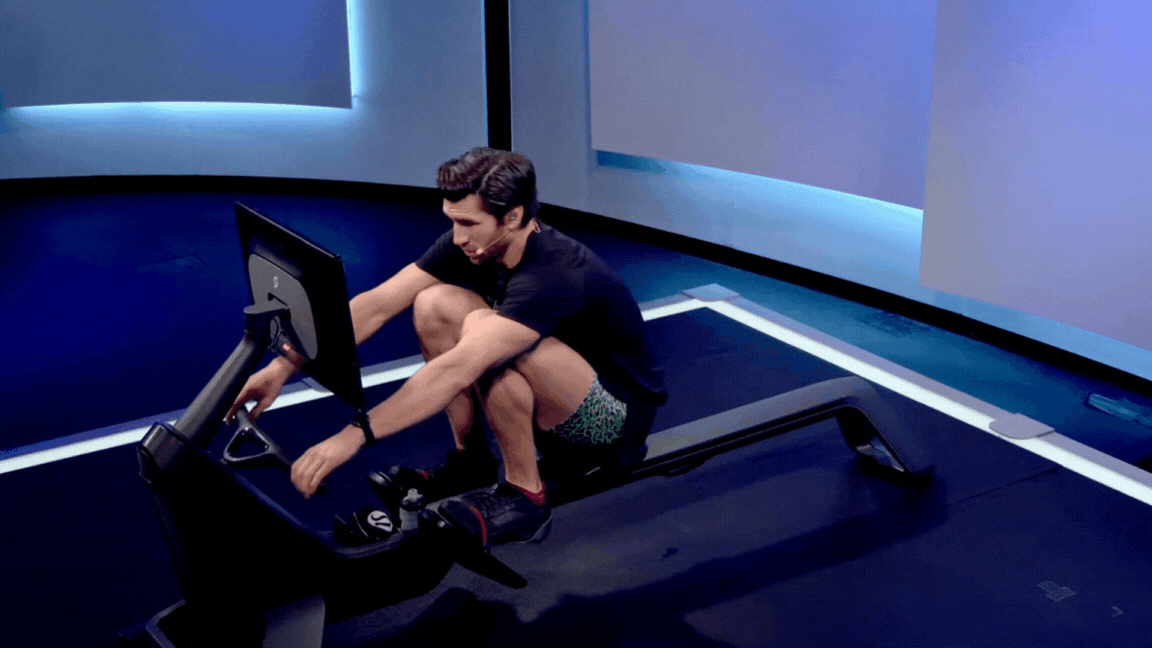 PEloton instructor Alex Karwoski demonstrates the drive phase of a rowing stroke on the Peloton Row.