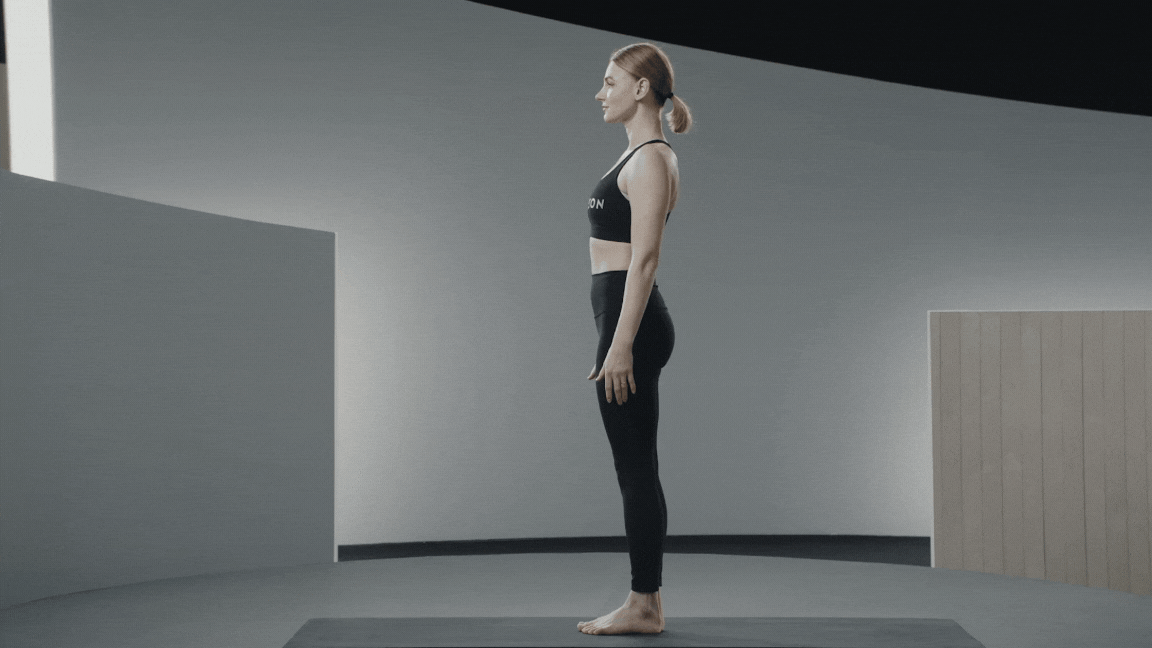 Peloton instructor Anna Greenberg demonstrates a Revolved Chair Pose, a yoga twist 