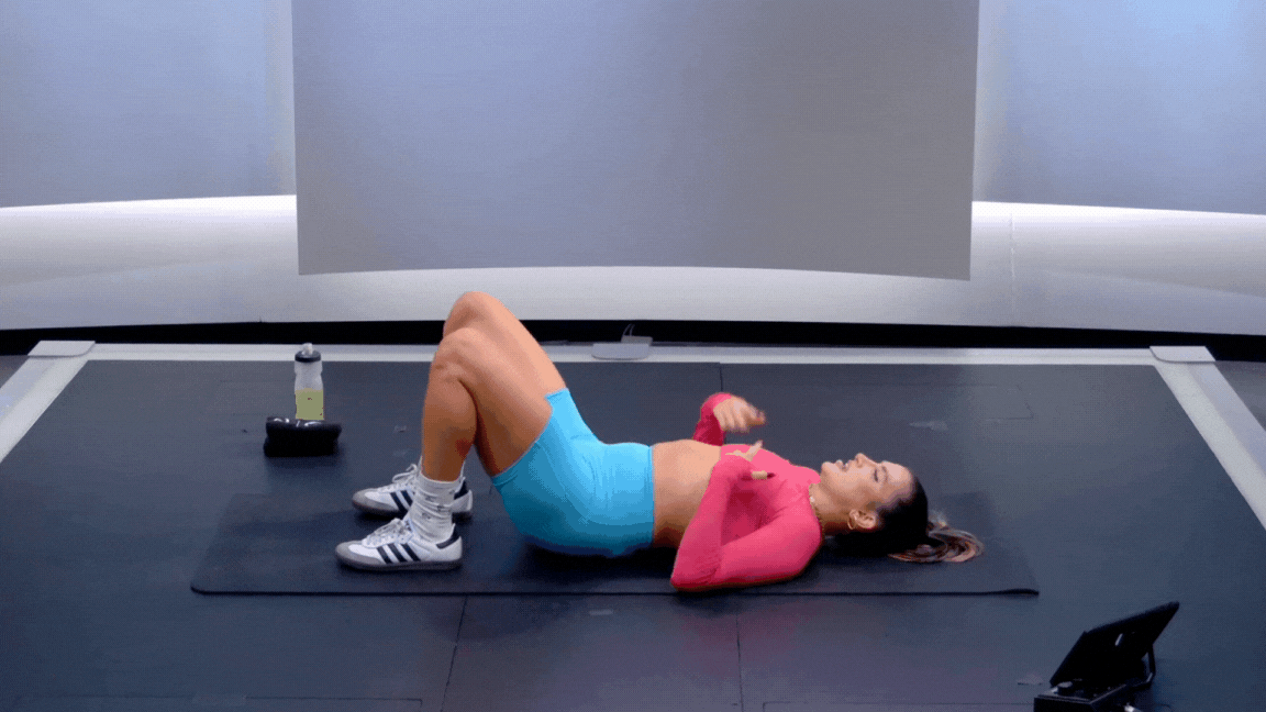Peloton instructor Camila Ramón demonstrates a hip bridge hold isometric exercise during a Peloton strength warm-up