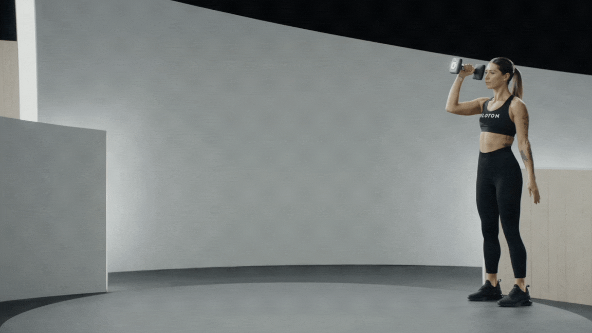 Peloton instructor Selena Samuela demonstrates a waiter's carry exercise, a variation of the farmer's carry, with proper form