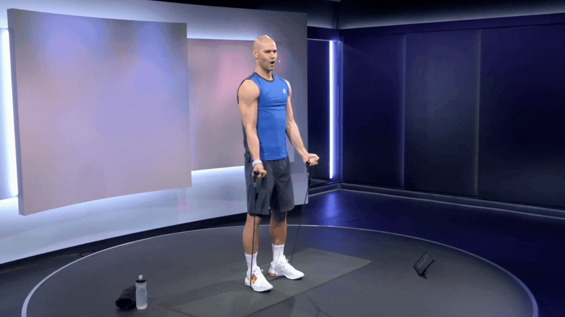 Peloton instructor Marcel Maurer demonstrates a resistance band biceps curl.