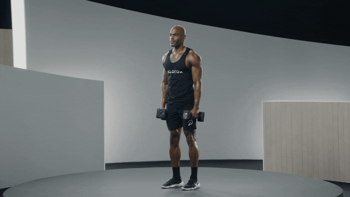 Peloton instructor Adrian Williams demonstrates a dumbbell lateral raise.