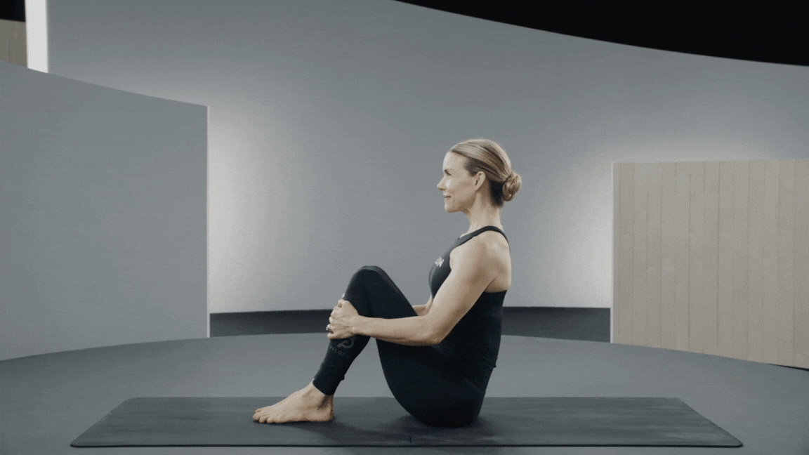 Peloton instructor Kristin McGee demonstrates boat pose in yoga with proper form