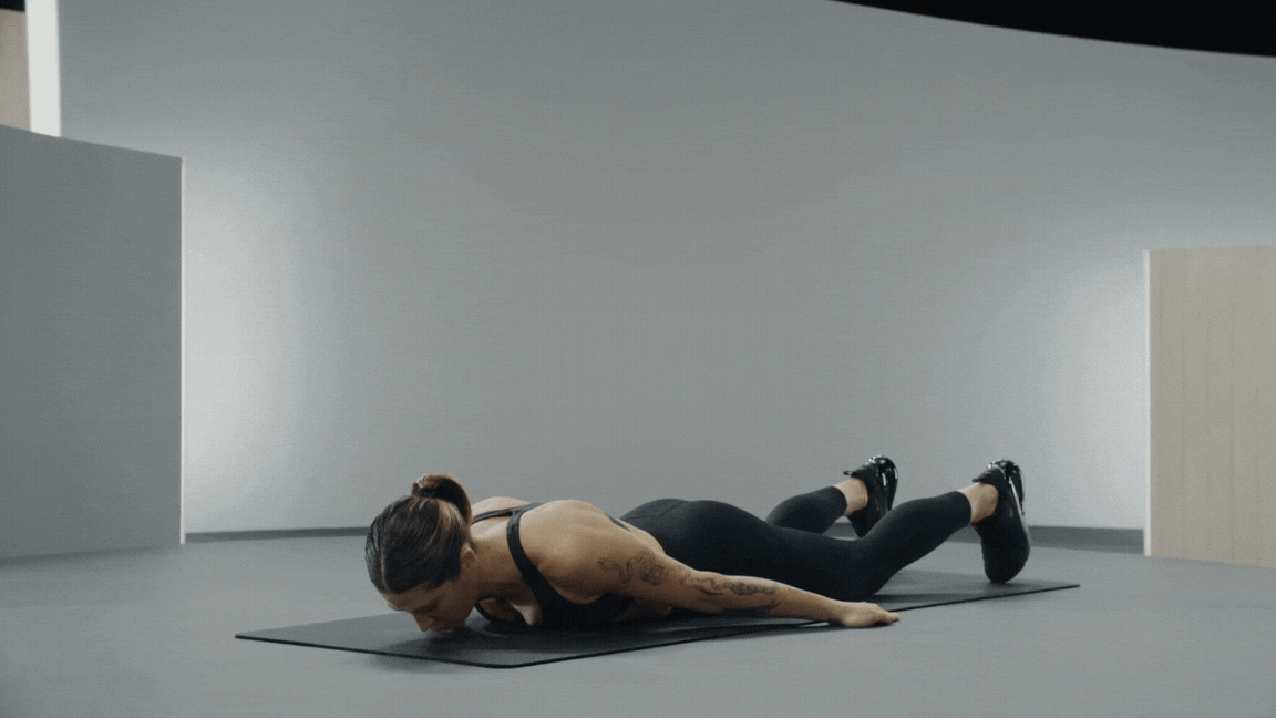 Peloton instructor Selena Samuela demonstrates a chest peel bodyweight back exercise.