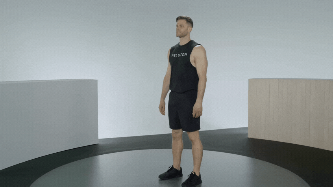 Peloton instructor Andy Speer demonstrates high knees as a workout warm-up exercise.