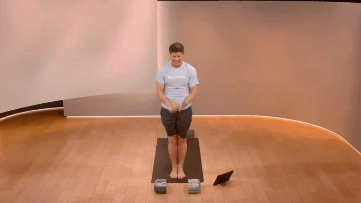 Peloton instructor Denis Morton demonstrates a Forward Fold Half Lift in yoga as a pose for the lower back.