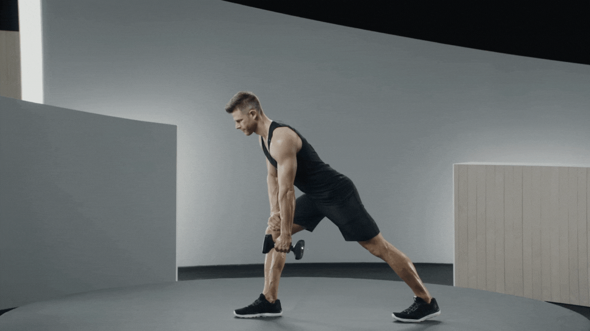 Peloton instructor Andy Speer demonstrates a lawn mover row lat exercise with proper form