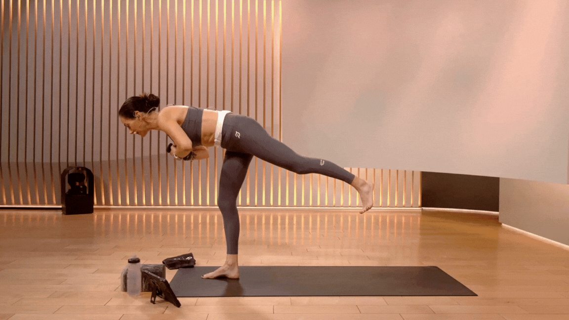 Peloton instructor Mariana Fernandez demonstrates Warrior 3 with weights during a yoga class with weights.