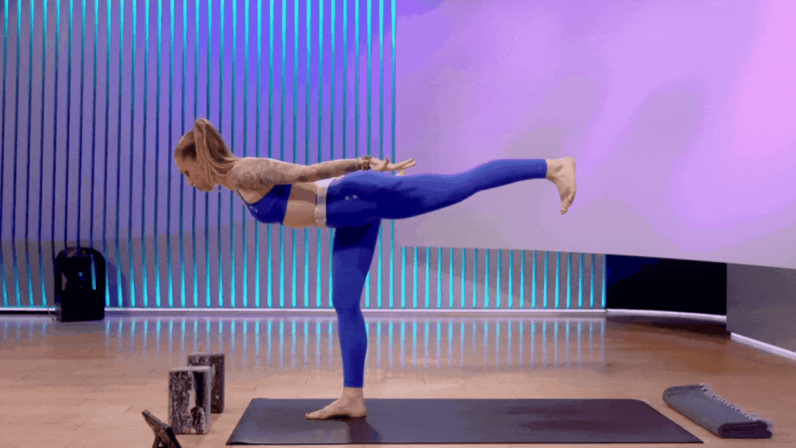 Peloton instructor Kirra Michel demonstrates Warrior 3 to Half Moon pose as a way to work hip internal rotation.