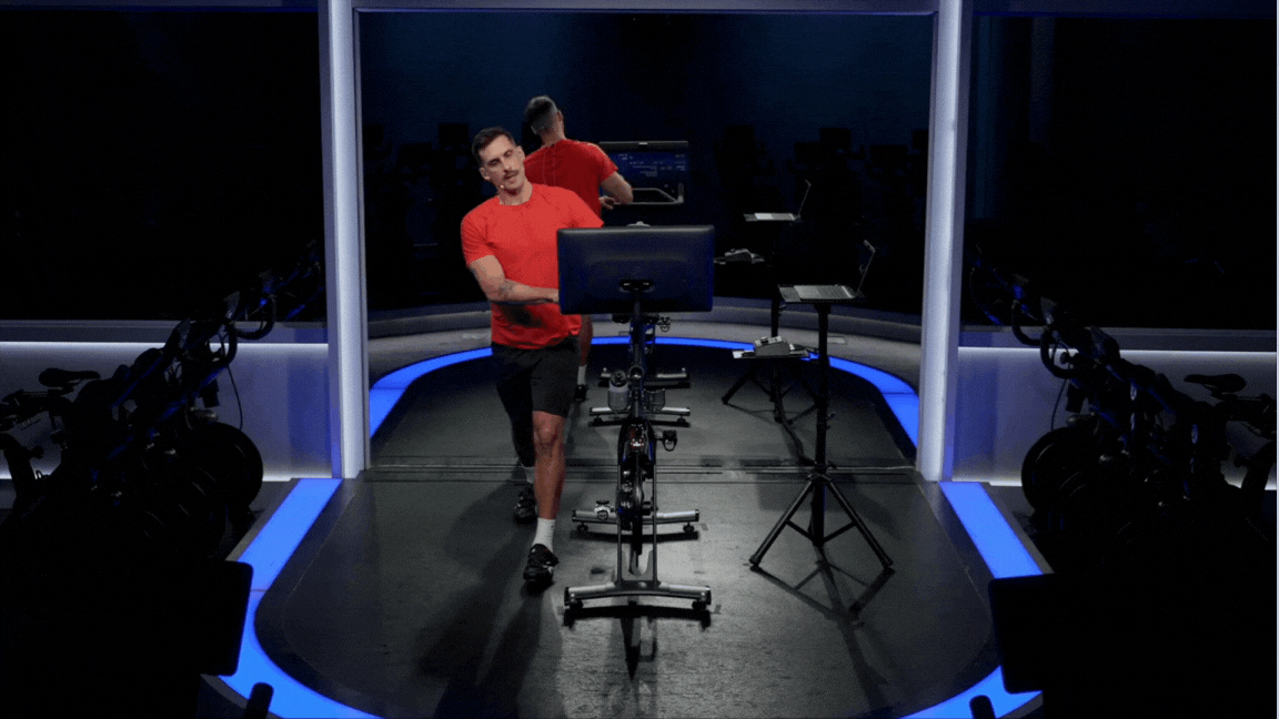 Peloton instructor Cody Rigsby demonstrates a standing side bend QL stretch.