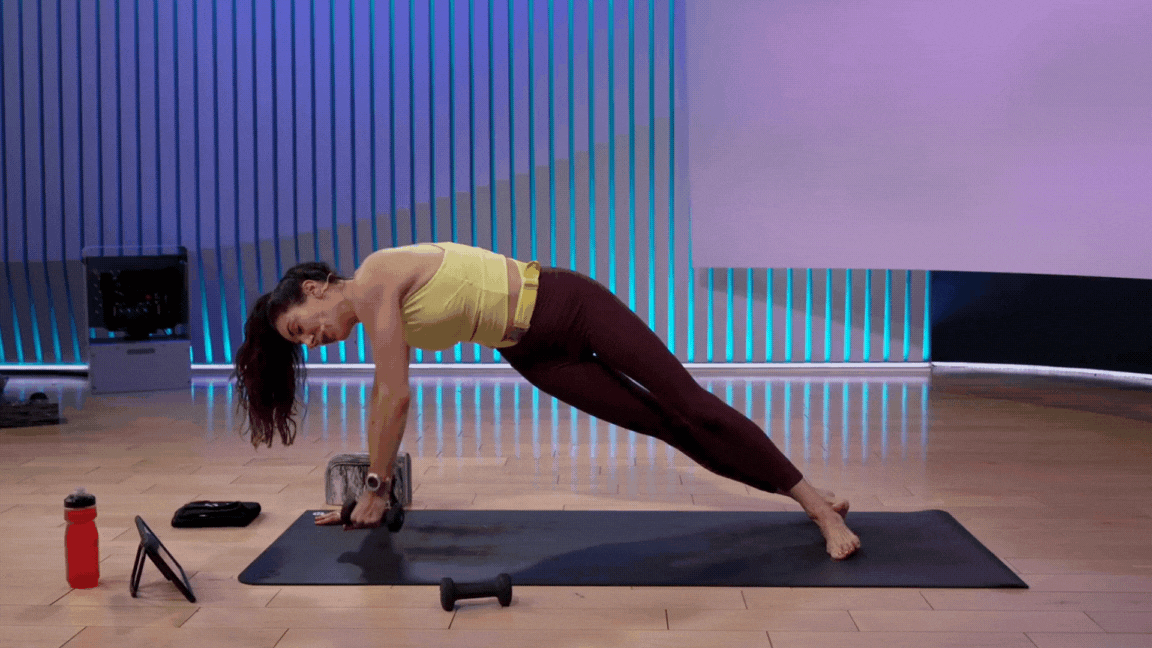 Peloton instructor Mariana Fernandez demonstrates Side Plank with weights during a yoga class with weights.