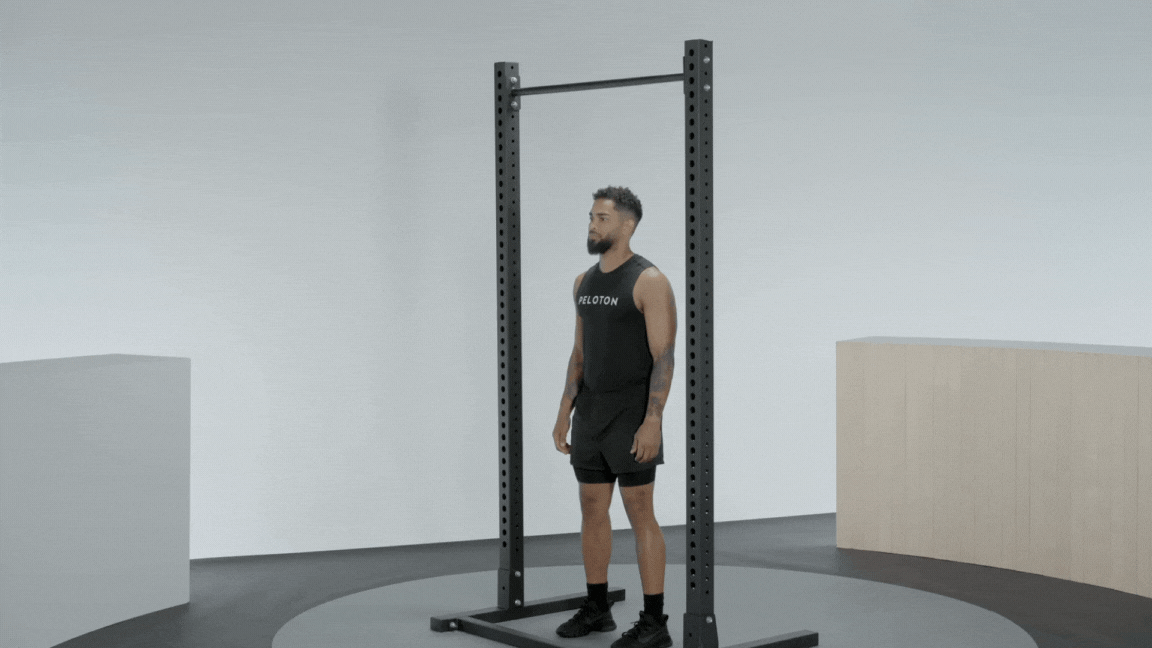 Peloton instructor Rad Lopez demonstrates a pull-up with proper form as a recommended rear delt exercise.