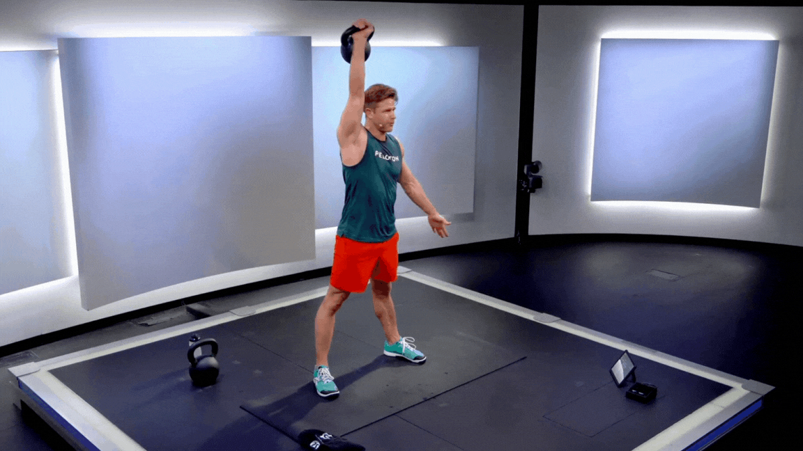 Peloton instructor Andy Speer demonstrates a kettlebell snatch back exercise with proper form during a Peloton kettlebell strength class.