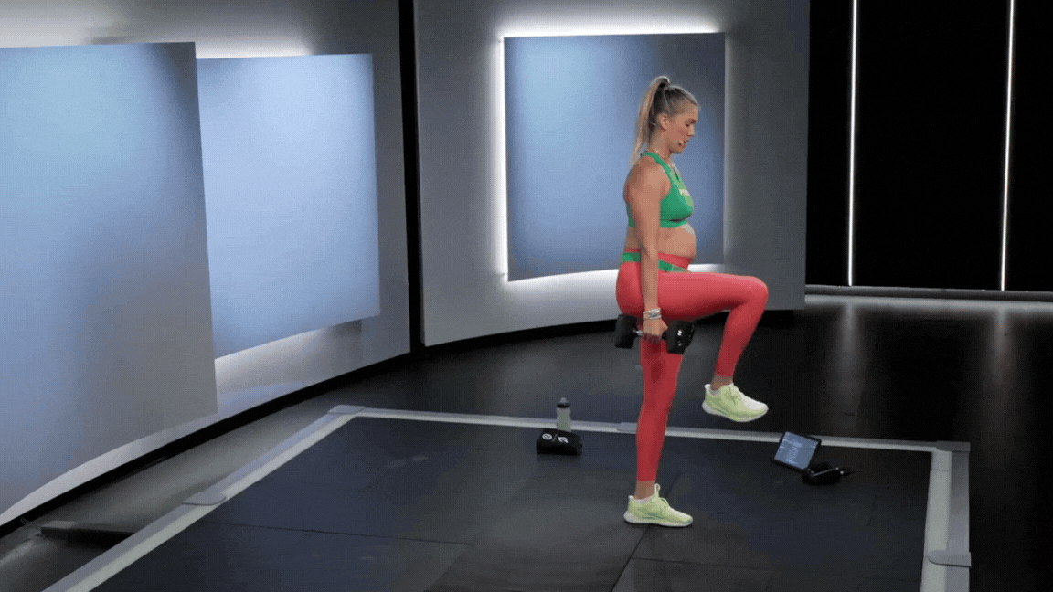 Peloton instructor Callie Gullickson demonstrates a reverse lunge to knee drive dumbbell leg exercise.