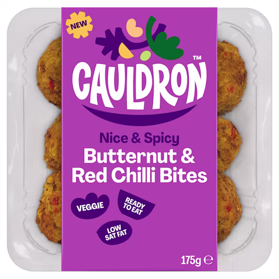 Cauldron Butternut & Red Chilli Bites in white packaging with a purple sleeve featuring the Cauldron logo and packaging weight. Six butternut squash bites can be seen behind the packaging sleeve. 