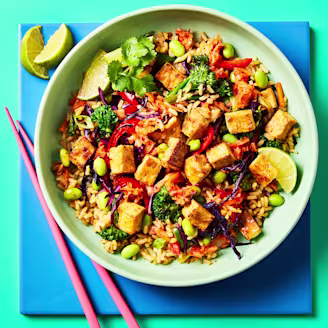 Colourful kimchi and tofu stir fry with vegetables, edamame beans, rice and Cauldron naked tofu pieces.