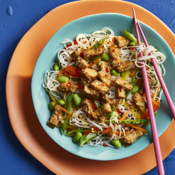 Marinated Tofu with Asian Noodles Salf on a blue plate with pink chopsticks 