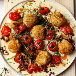 Middle Eastern vegan mezze platter made with Cauldron falafel topped with roasted tomatoes