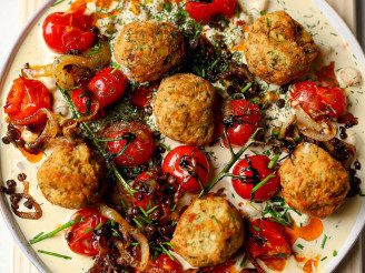 Middle Eastern vegan mezze platter made with Cauldron falafel topped with roasted tomatoes