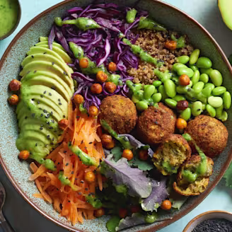 Falafel and quinoa Buddha bowl with peas in a bowl