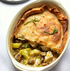 Vegan Tofu Leek Pie with a slice missing to showcase the filling served in a white dish