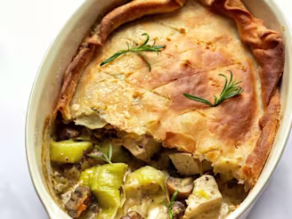Vegan Tofu Leek Pie with a slice missing to showcase the filling served in a white dish