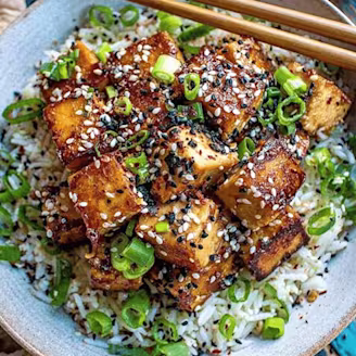 Sticky tofu rice bowl with crispy tofu in a bowl
