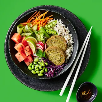 Cauldron Spinach and Carrot Veggie Bakes served in a dark dish with white chopsticks on the side