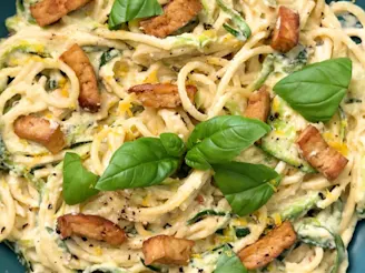 A close up image of Cauldron tofu and courgette pasta garnished with basil