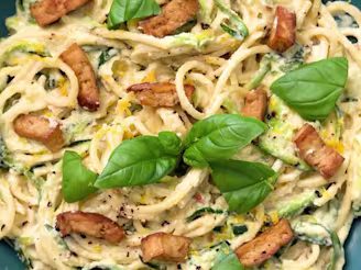 A close up image of Cauldron tofu and courgette pasta garnished with basil