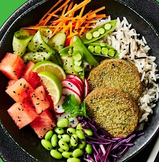 Cauldron spinach veggie bakes in a vegetable bowl with rice on the side in a black dish