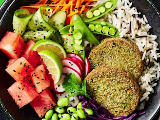 Cauldron spinach veggie bakes in a vegetable bowl with rice on the side in a black dish