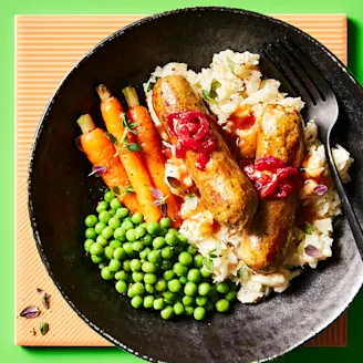 Cauldron Linconshire sausages, mash, carrots and peas on a plate