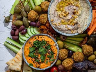Middle Eastern Mezze Platter with several veggies and falafel on display