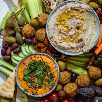 Middle Eastern Mezze Platter with several veggies and falafel on display