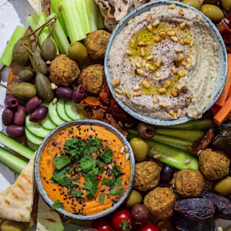 Middle Eastern Mezze Platter with several veggies and falafel on display