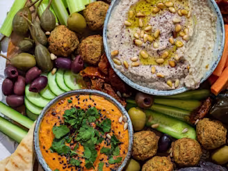 Middle Eastern Mezze Platter with several veggies and falafel on display