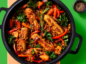 Cauldron Lincolnshire Sausage and lentil casserole with roasted veg served in a dark dish with a green background 
