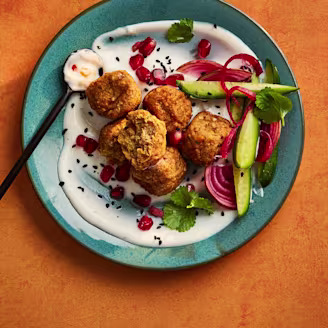 Cauldron Middle Eastern falafel bites with yoghurty dip on a plate