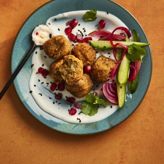 Cauldron Middle Eastern falafel bites with yoghurty dip on a plate