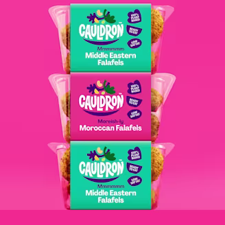 Three Cauldron ffalafel packs stacked on a pink background